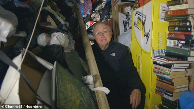 Paul, 72, (pictured sitting on his stairs surrounded by his hoard-filled hallway) decided to clear out his cluttered home in Crosby, Merseyside, to fund his retirement after collecting items for 25 years following the death of his mother in 1995