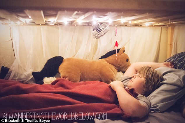 Alone time: Zack, 11, sleeps to one side of his parents on a sort of bottom bunk; he has a curtain for privacy